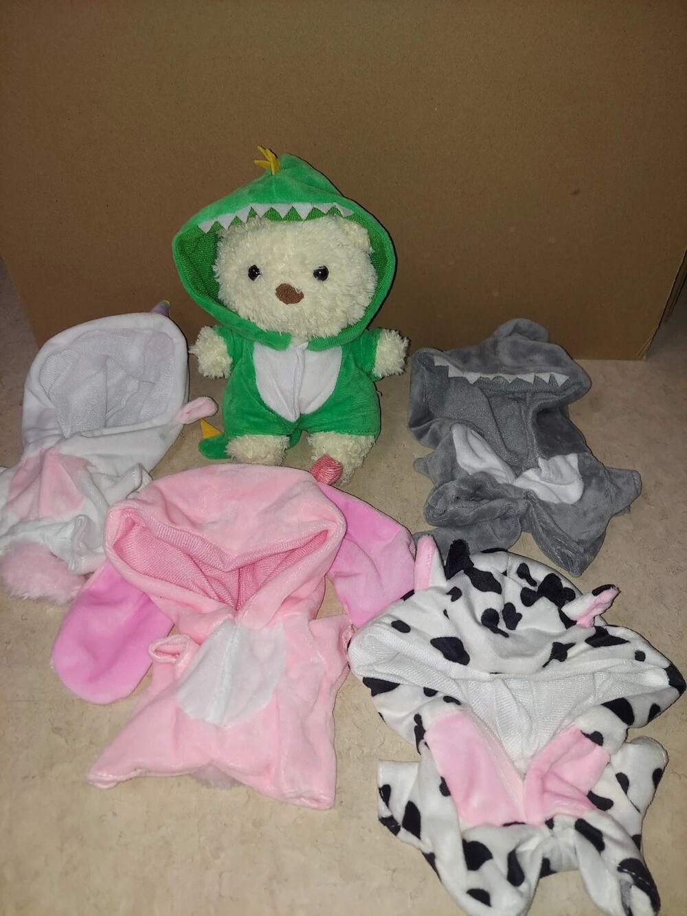 Bartholomew Bear Junior from Jellycat with outfits with tag